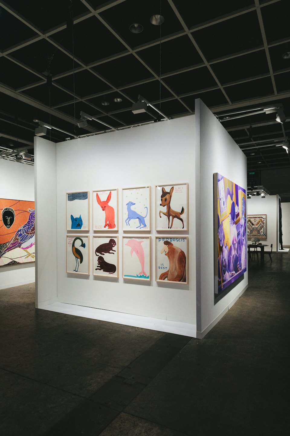 Animal illustrations and purple abstract art displayed in a gallery.